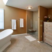 Solid surface alcove shower with an extended bench seat 