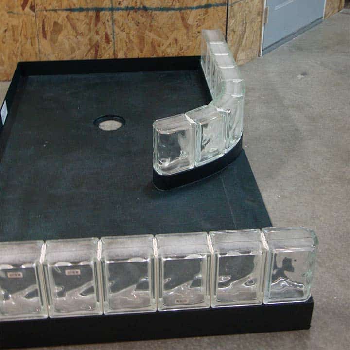 Expanded polystyrene shower base with prefab curved glass block sections - Innovate Building Solutions 