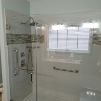 Solid surface shower with window trim bench seat and tile borders 