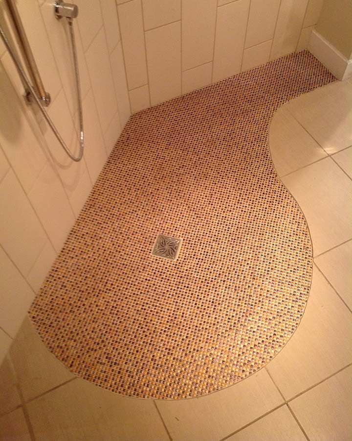 Tiled wet room shower base with a one level bathroom floor - Innovate Building Solutions 