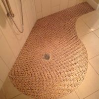 Circular waterproof tile floor with large format bathroom tiles - Innovate Building Solutions 