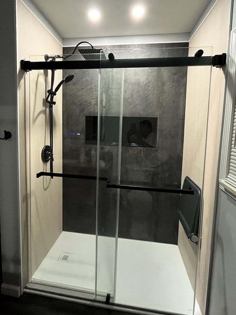 Matte black shower alcove glass bypass doors in a remodel and shower base in Cleveland Ohio - The Bath Doctor 