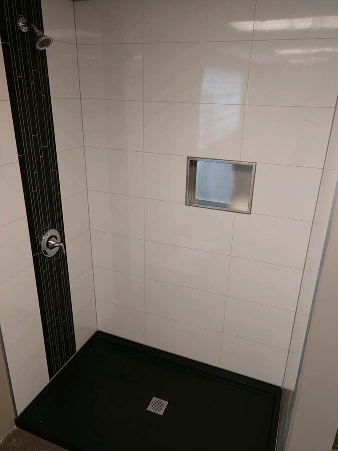 Shower replacement in Cleveland with high gloss laminate shower pans and a black accent trim - The Bath Doctor 