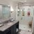 Solid surface shower remodel with a custom glass shower door system - The Bath Doctor Lakewood Ohio 