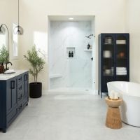White Carrara shower wall panels paired with navy blue cabinetry create a timeless yet bold bathroom design, combining classic marble beauty with modern contrast and low-maintenance performance.