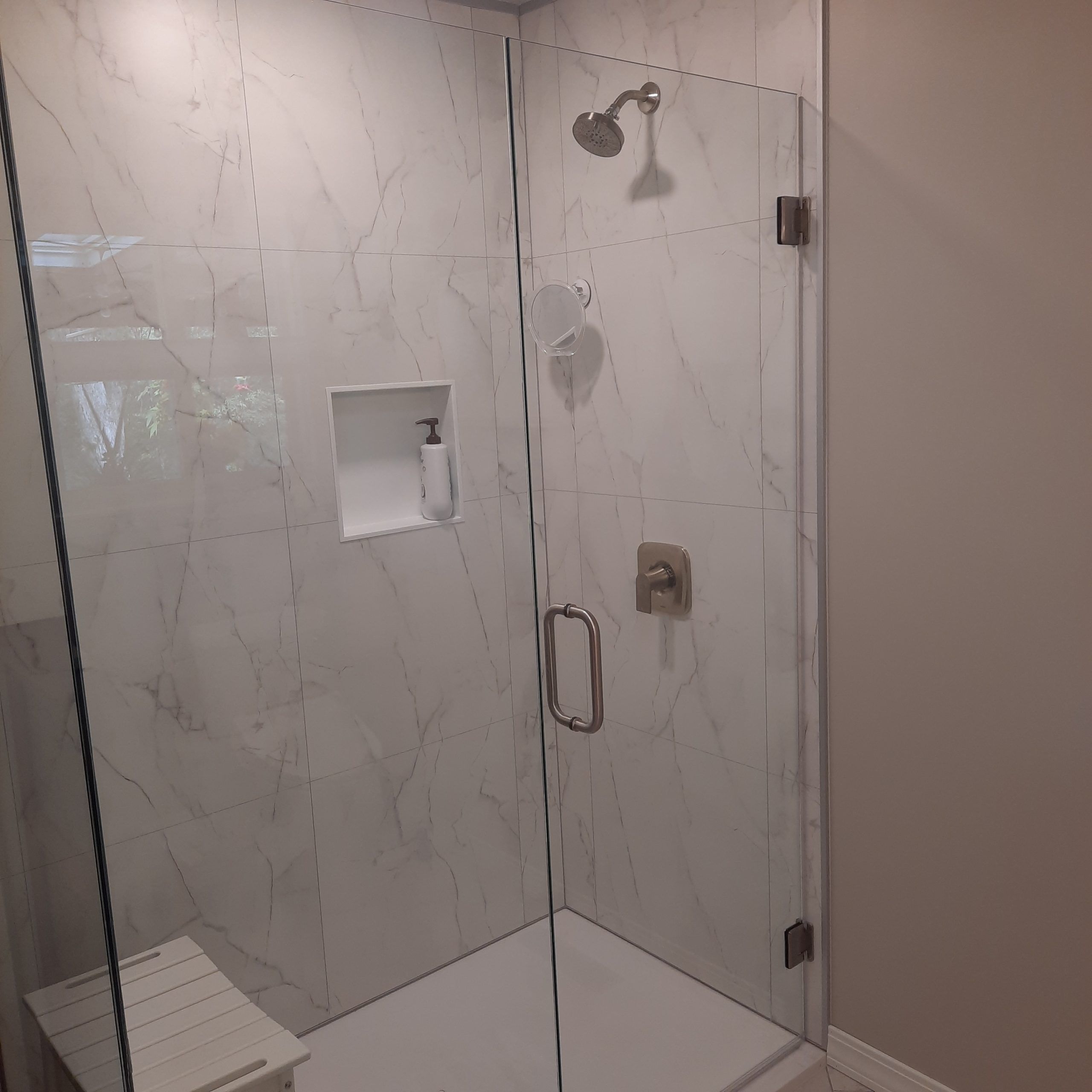 Frameless pivoting glass shower doors and acrylic base in a Hunting Valley remodel in Cleveland - The Bath Doctor 