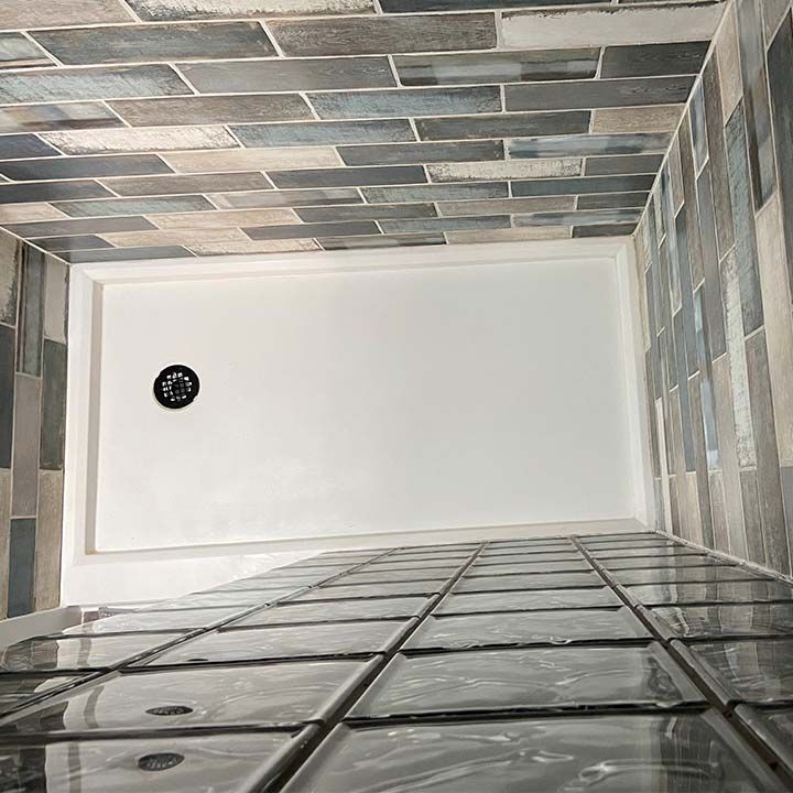 Solid surface shower pan with a straight glass block wall (top down view) 