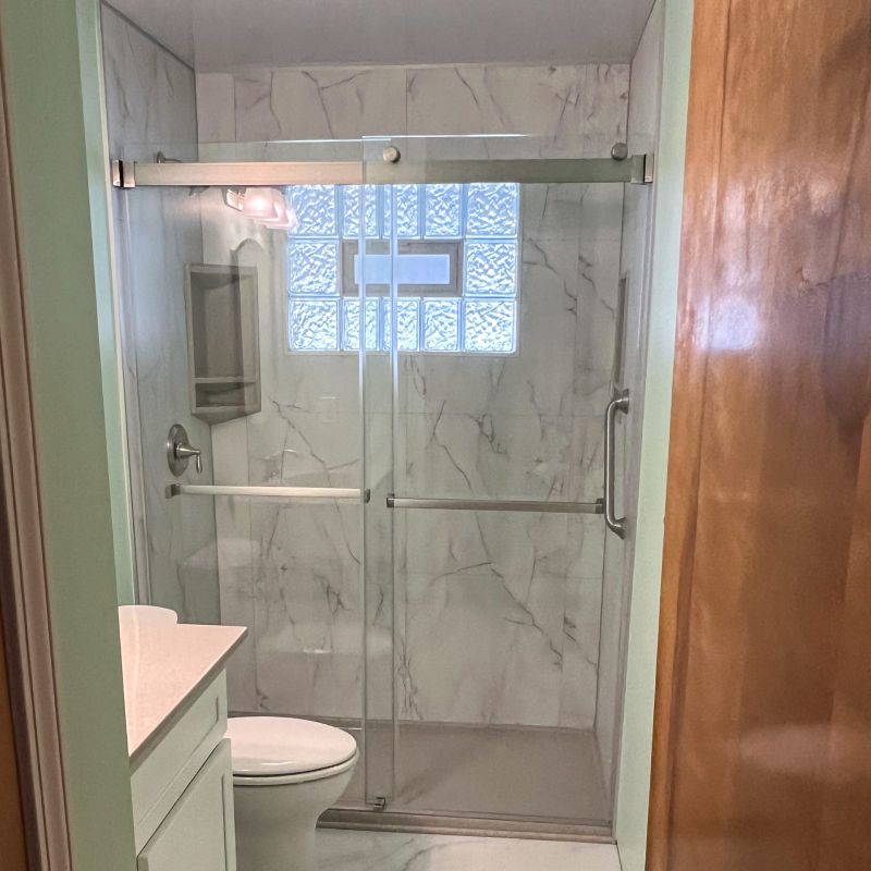 After_Bianco Marble Wall Panels with Solid Surface Base and Glass Block Bathroom Window (2) | Bathroom Remodeling Services | Tub to Shower Conversion in Akron Ohio