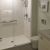 60 x 36 white cultured marble shower pan with a center drain and bypass sliding shower doors - Innovate Building Solutions 