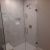 Frameless pivoting glass shower doors and acrylic base in a Hunting Valley remodel in Cleveland - The Bath Doctor 