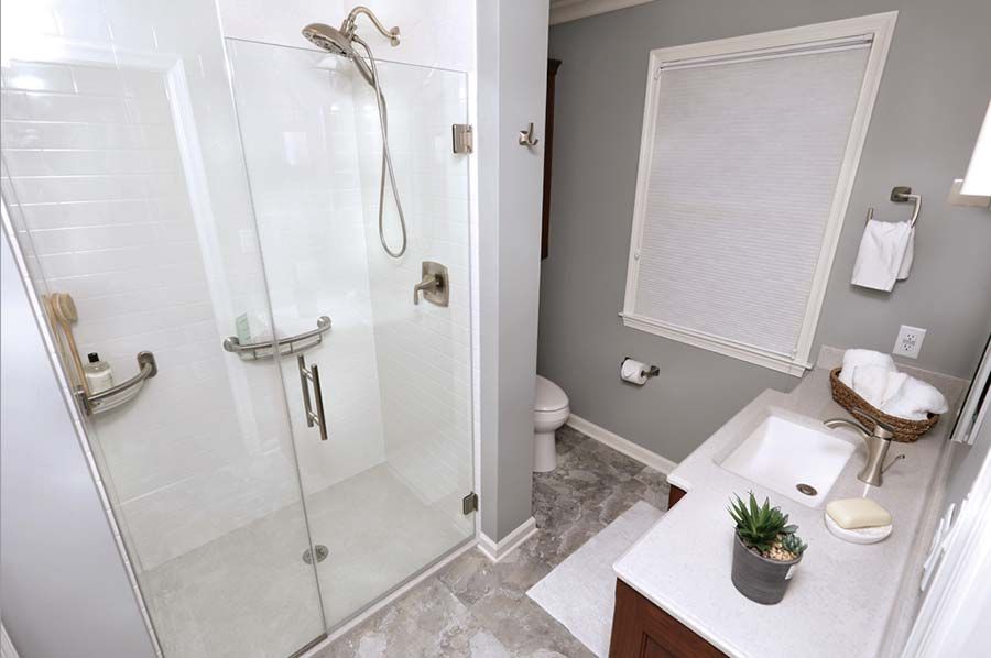 Shower remodeling project in Highland Heights with a low curb shower pan and pivoting glass shower door - The Bath Doctor 