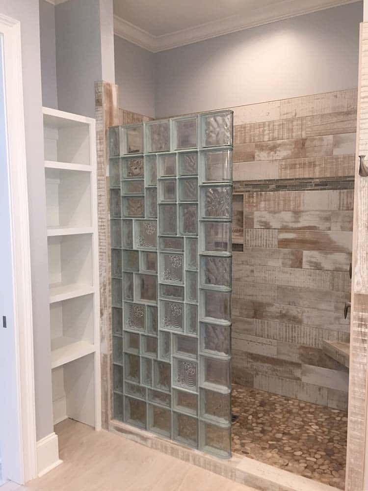 Multi-pattern glass block prefabricated wall on a tile shower base - Innovate Building Solutions 