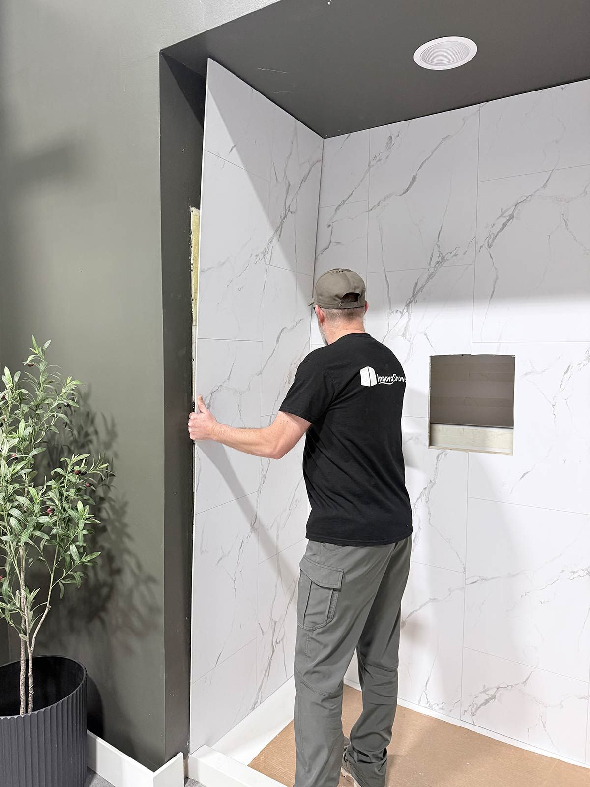 Shower wall panel being installed
