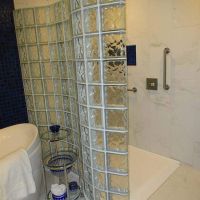Serpentine glass block shower with a ramped shower pan - The Bath Doctor 