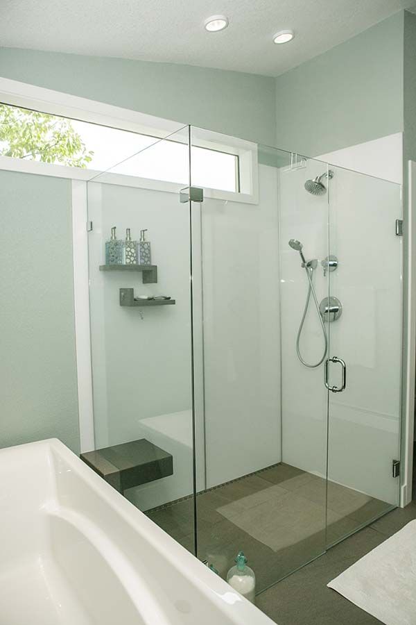 Pivot shower doors and high gloss wall panels in a corner shower in Pepper Pike Ohio - The Bath Doctor 