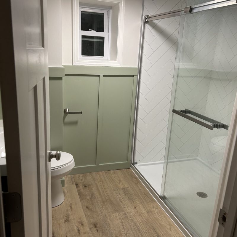 AFTER - shower replacement project - white herringbone wall panels