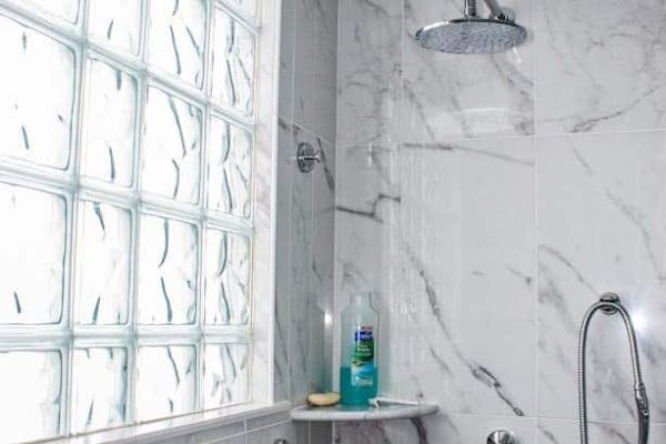 Glass block shower window around a marble tile - Innovate Building Solutions 