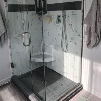 48 x 36 custom gray cultured granite shower pan with white and gray cultured marble wall panels and a corner seat - Innovate Building Solutions