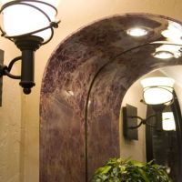 Brecchia paradiso PVC panel bent around an arched opening 