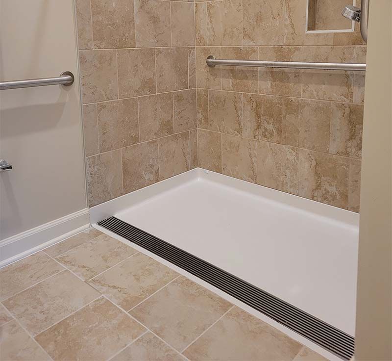 ramped shower pan with linear drain trench