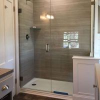 Shower base for a tub to shower conversion with Marina Gray Oak laminate wall panels - Innovate Building Solutions 