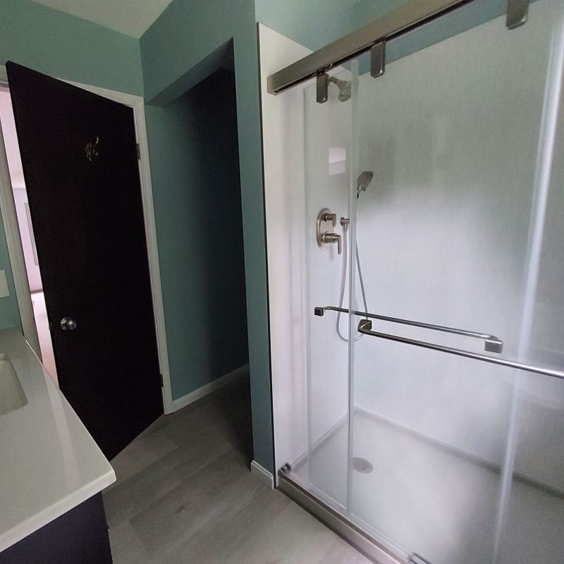 AFTER - White Solid Surface Grout Free Wall Panels & Sidling Glass Door in Broadview Heights Ohio
