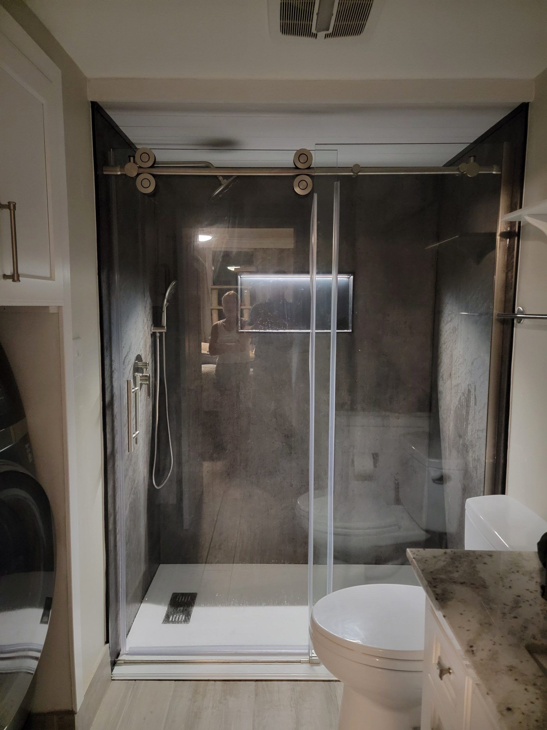 Walk-in alcove shower with glass shield and white pan