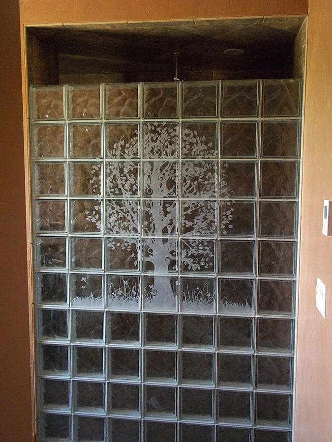 Etched tree mural in a wave pattern glass block shower - Innovate Building Solutions 