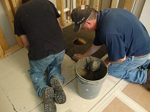 Thin set being applied before ready for tile shower base is set (note - with solid surface pans you don't need this step)