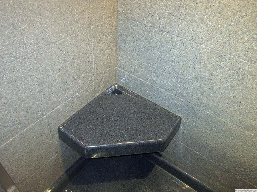 Angular corner seat in a solid surface shower - Innovate Building Solutions 