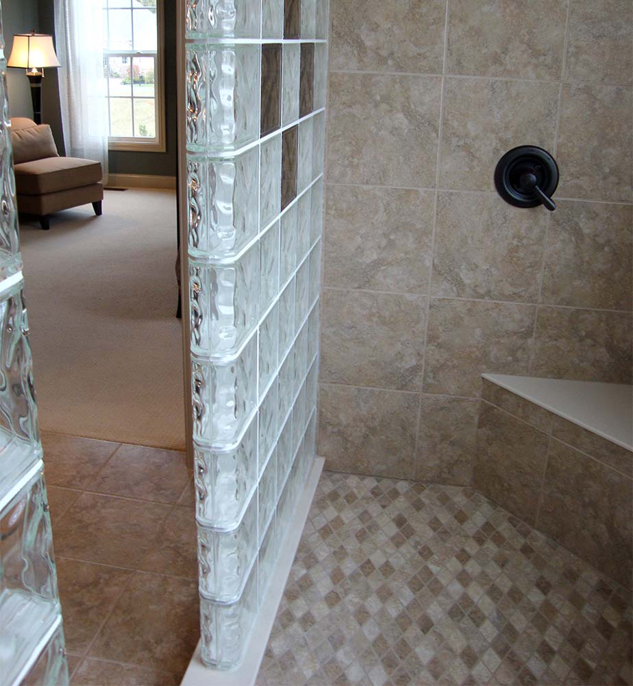 Bench seat in a 2 sided glass block walk in shower wall design