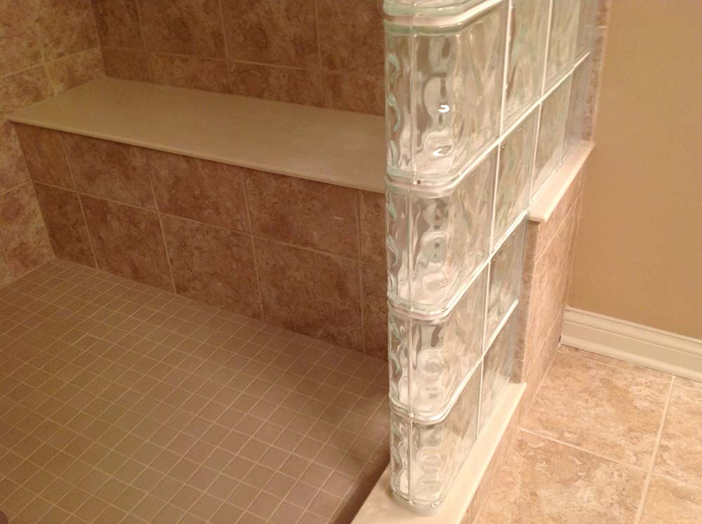 Bench seat in a step down tile glass block shower