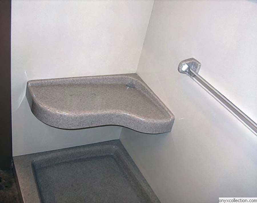 Extended corner bench seat in a traditional solid surface shower - Innovate Building Solutions 
