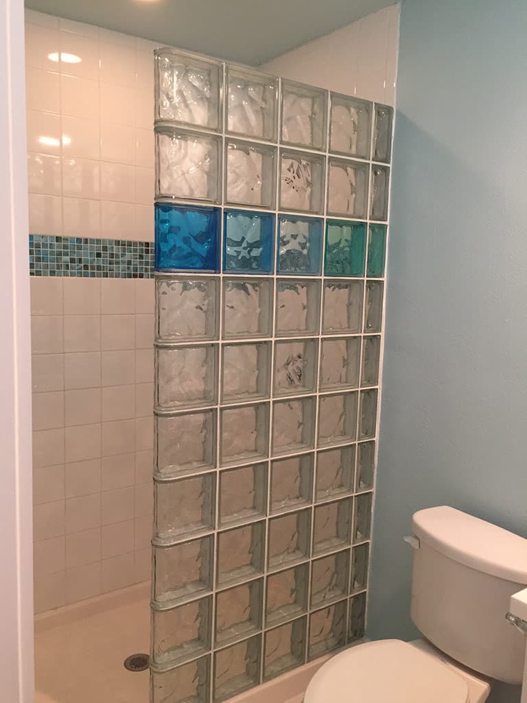Blue and green wave glass blocks in a shower wall - Innovate Building Solutions 