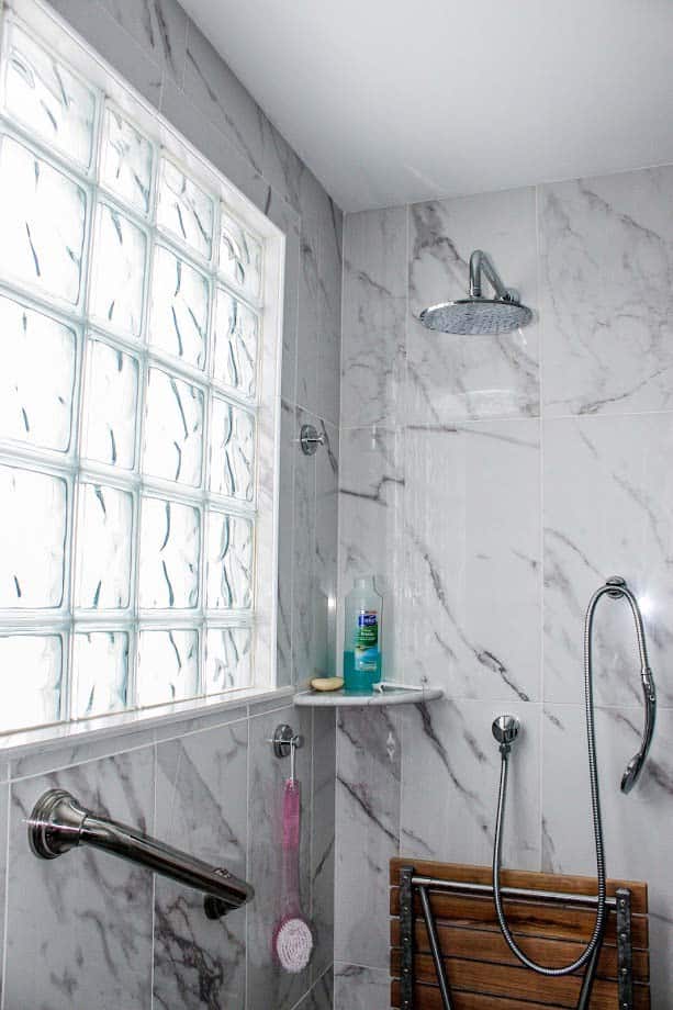 Glass block shower window around a marble tile - Innovate Building Solutions 