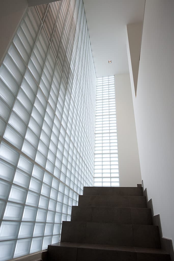 Frosted half-sized glass blocks in a modern stairwell - Innovate Building Solutions 