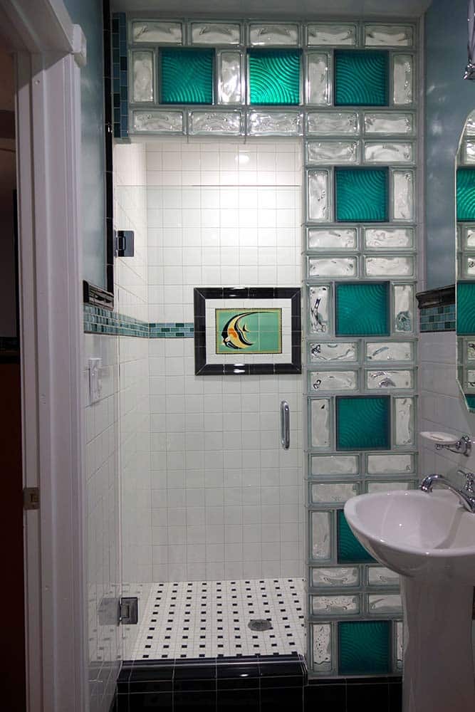 Colored glass block full blocks with wave pattern half blocks in a small shower with a pivoting door - Innovate Building Solutions 
