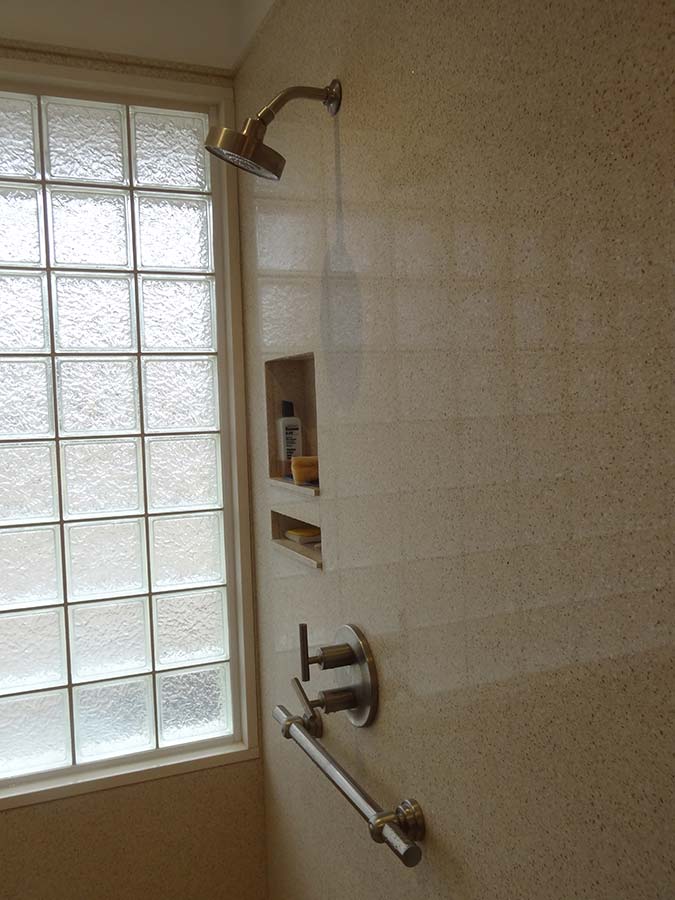 Universal design shower with glass block privacy window and easy to work lever type hardware and decorative grab bar - Innovate Building Solutions 