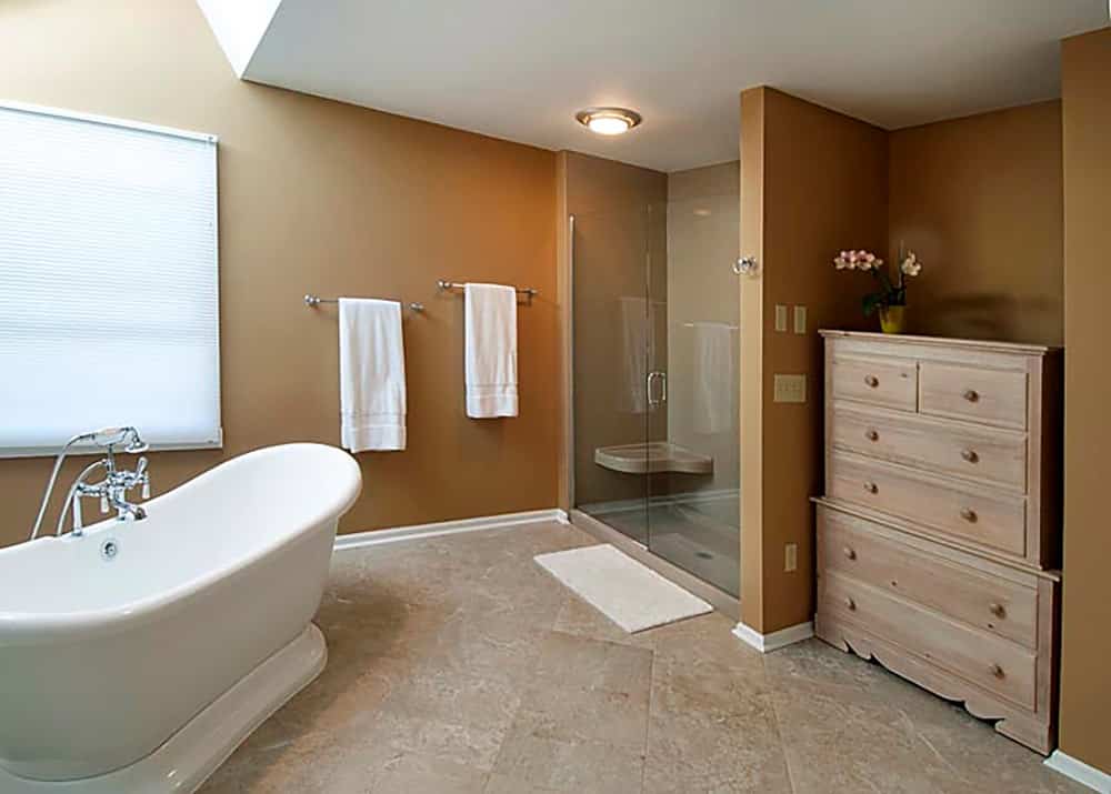 Solid surface alcove shower with an extended bench seat 