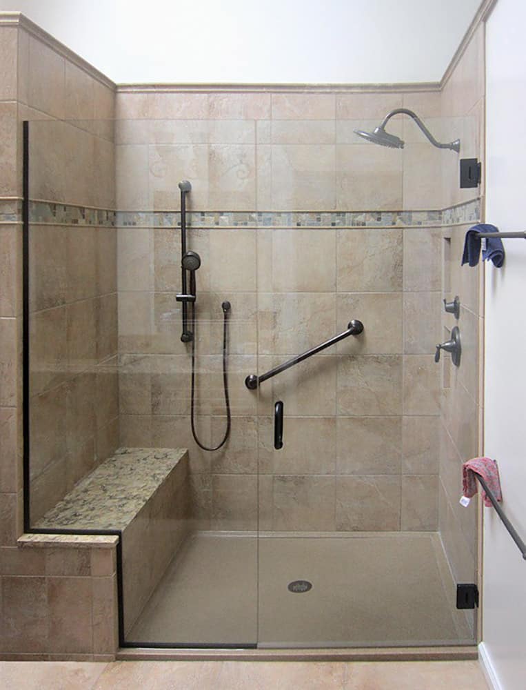 Cultured granite shower pan with tile wall surrounds and a granite bench seat 
